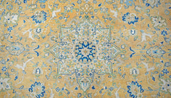 A vintage Persian Kashan rug featuring an intricate floral medallion in blue and cream on gold.