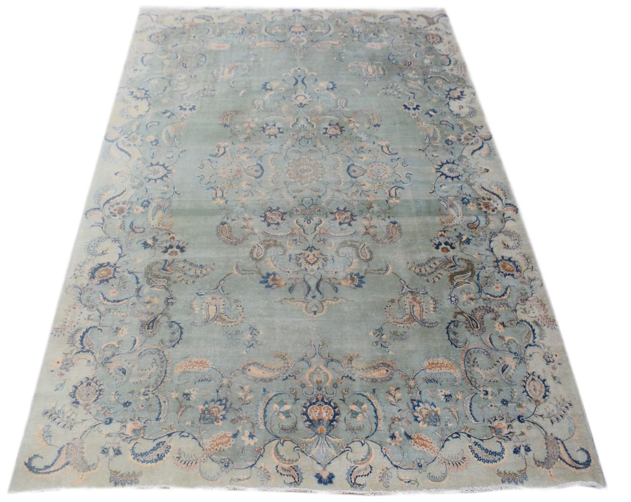 A vintage handmade Persian Kashan rug featuring an intricate floral medallion on a light blue field.