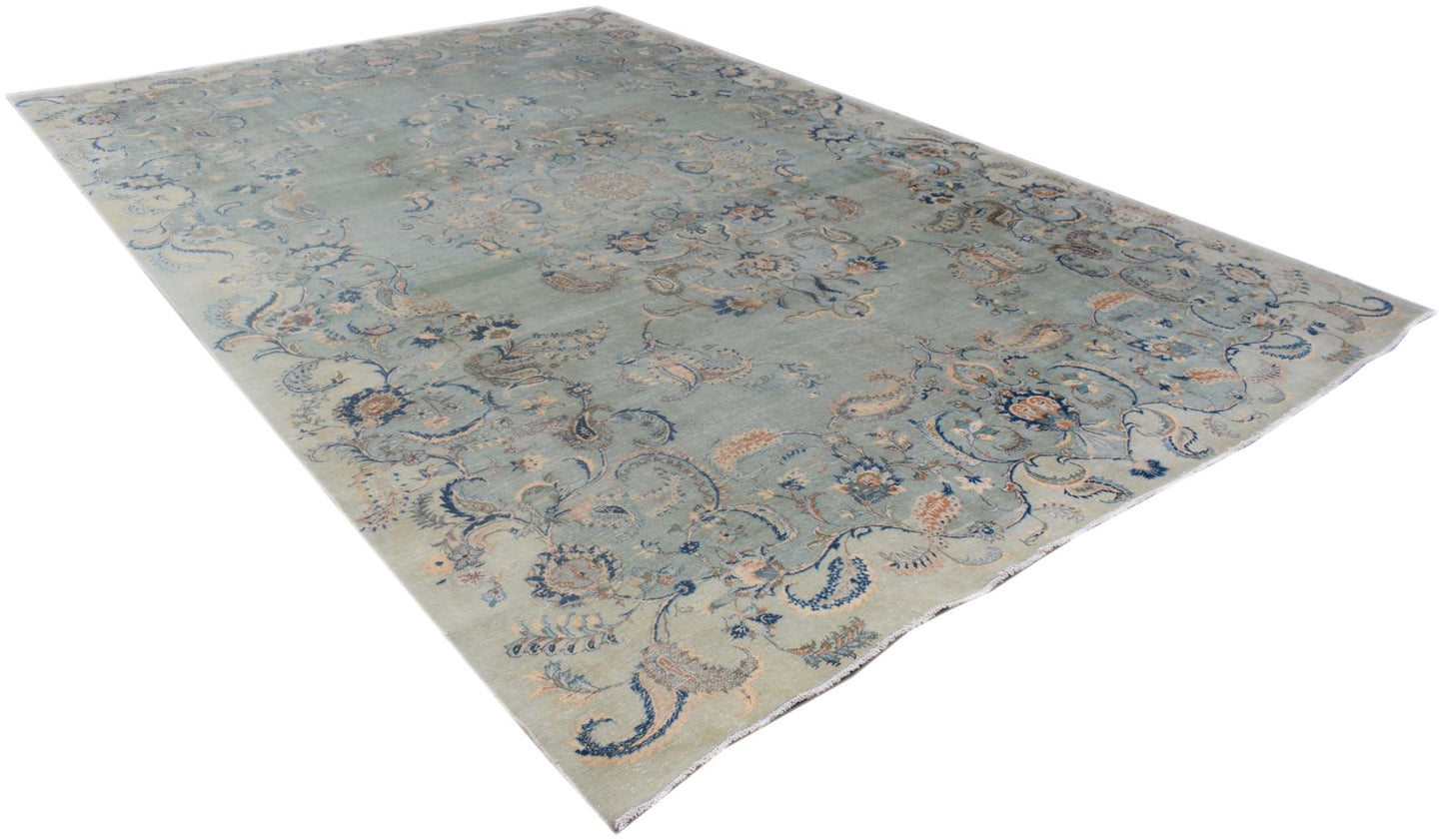 A vintage Persian Kashan rug featuring intricate floral patterns in blue and beige tones.