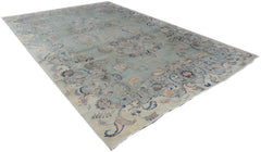 A vintage Persian Kashan rug featuring intricate floral patterns in blue and beige tones.