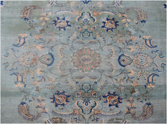 A vintage Persian Kashan rug featuring a central floral medallion on a light blue field.