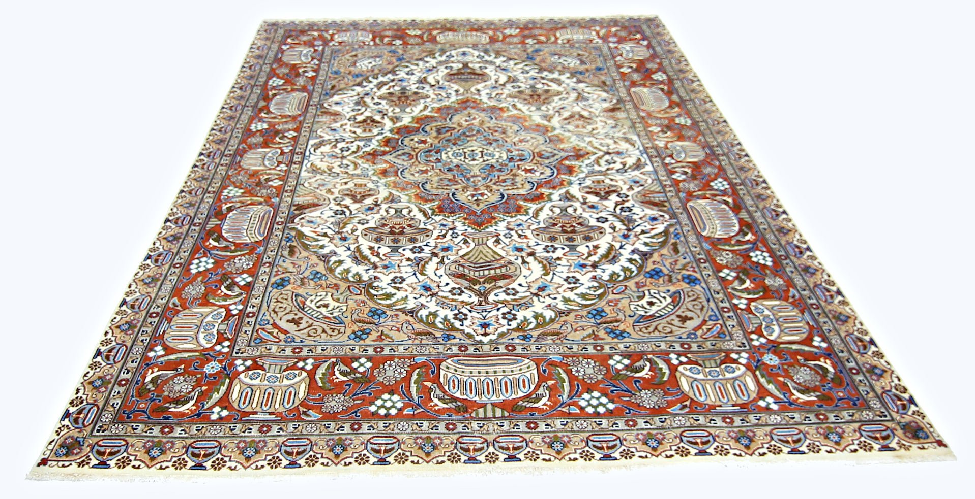 A vintage Persian Kashmar rug featuring an intricate floral and vase pattern in red, blue, and cream.