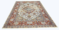 A vintage Persian Kashmar rug featuring an intricate floral and vase pattern in red, blue, and cream.