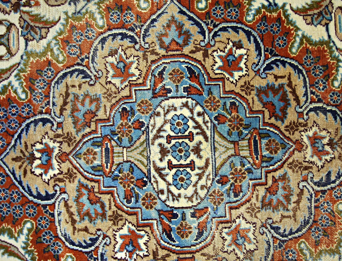 A vintage Persian Kashmar rug featuring an intricate floral medallion pattern in blue and rust tones.