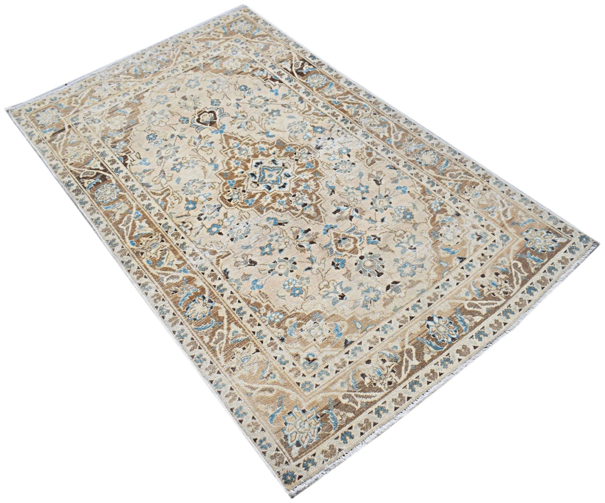 A vintage Persian Kerman rug featuring a central medallion and intricate floral patterns in blue.