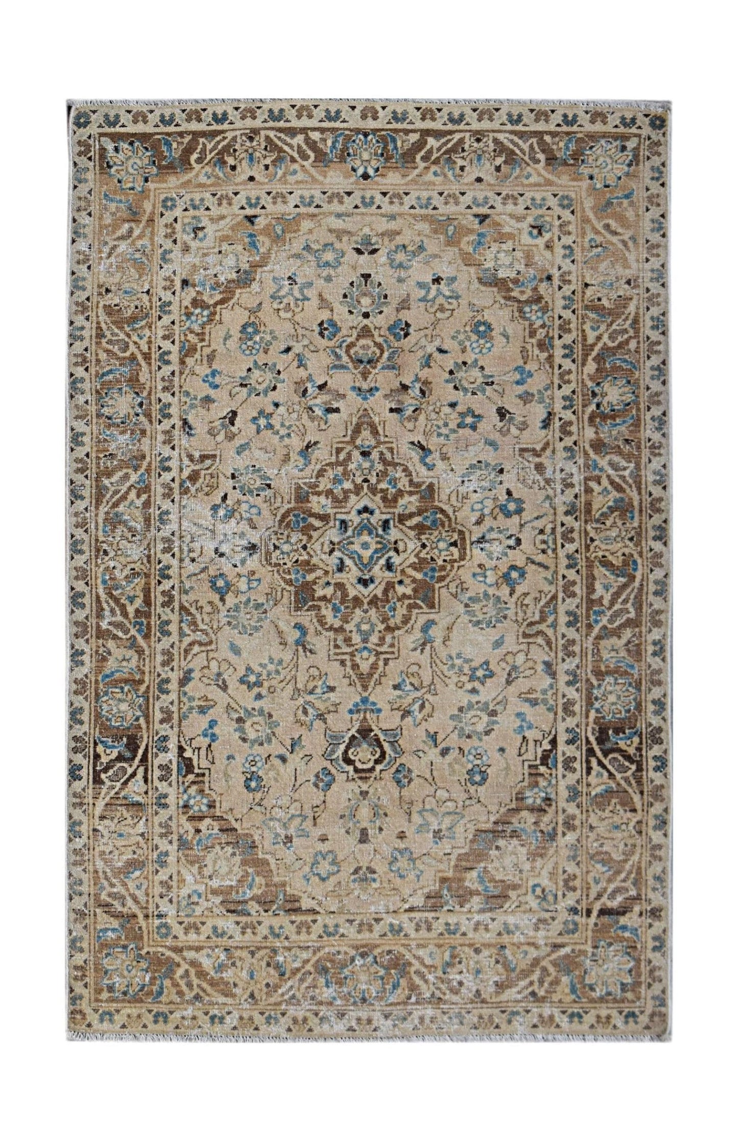 A vintage Persian Kerman rug featuring a central medallion and intricate floral patterns in blue.