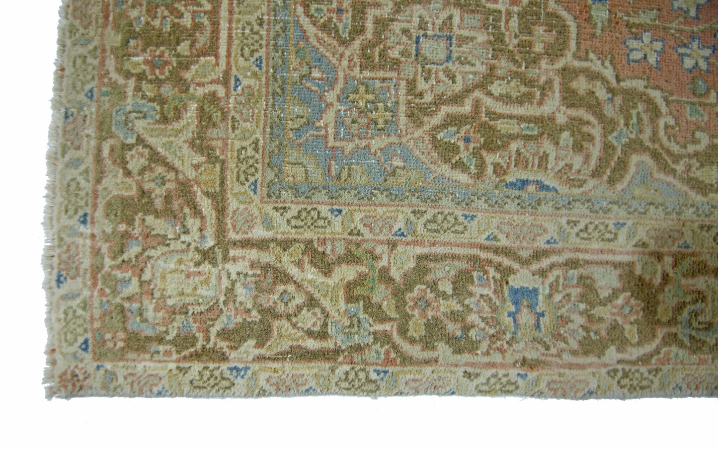 A vintage handmade Persian rug featuring intricate floral patterns in muted earth tones.