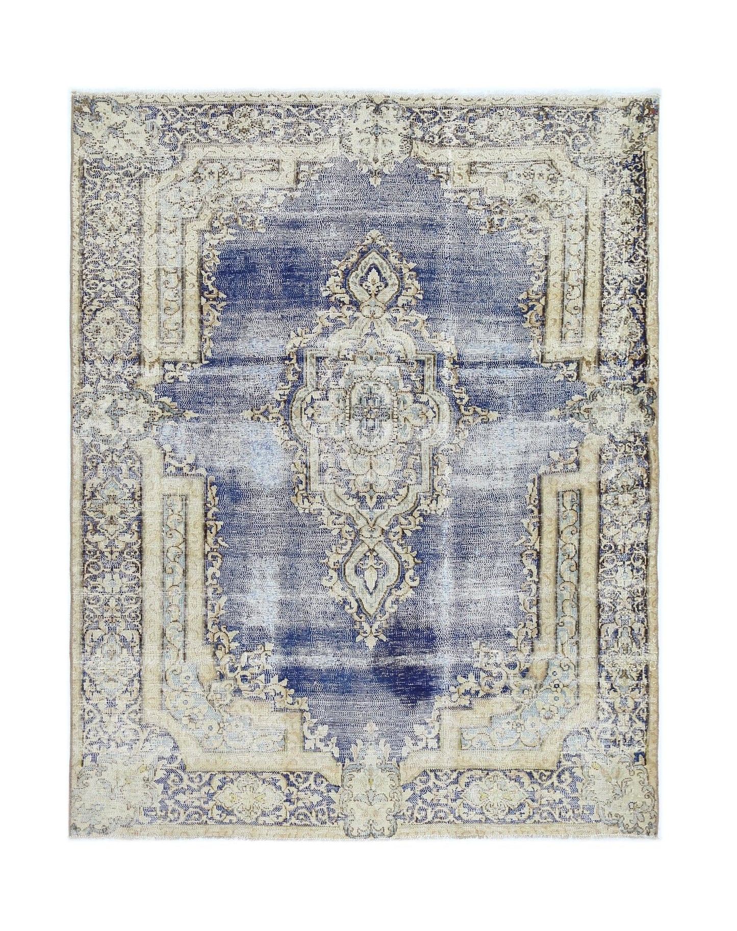 A vintage Persian Kerman rug featuring a central medallion and floral motifs in blue and beige.