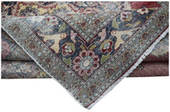 A vintage Persian Kerman rug featuring a dark blue border with intricate floral and animal motifs.