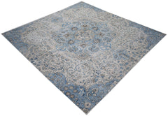 A vintage Persian Kerman rug featuring a central medallion and intricate floral patterns in blue.