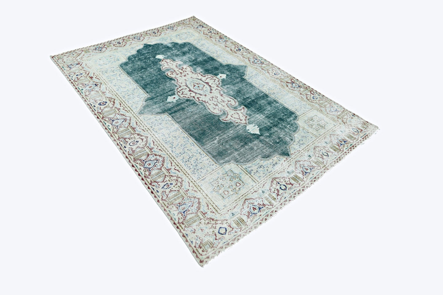 A vintage Persian Kerman rug featuring a central medallion on a teal field with floral borders.