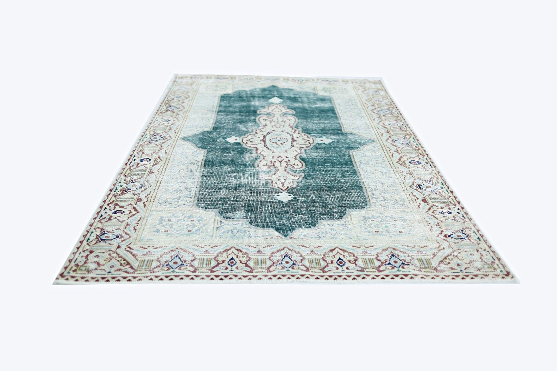 A vintage Persian Kerman rug featuring a central medallion on a teal field with floral borders.