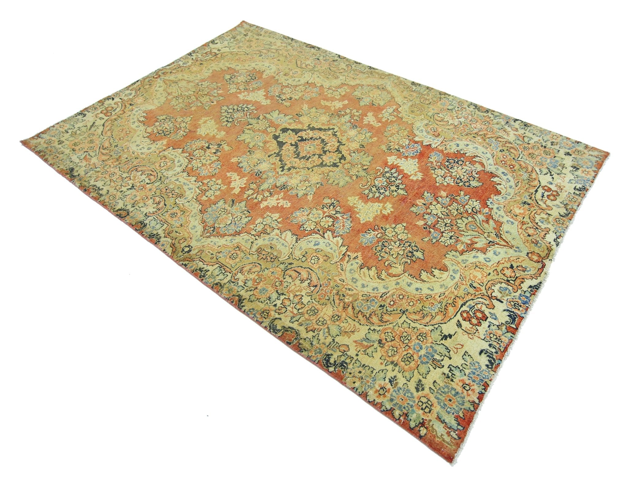 A vintage Persian Kerman rug featuring an intricate floral medallion design in orange and cream.