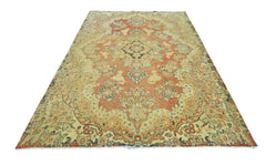 A vintage Persian Kerman rug featuring a central medallion and intricate floral patterns.