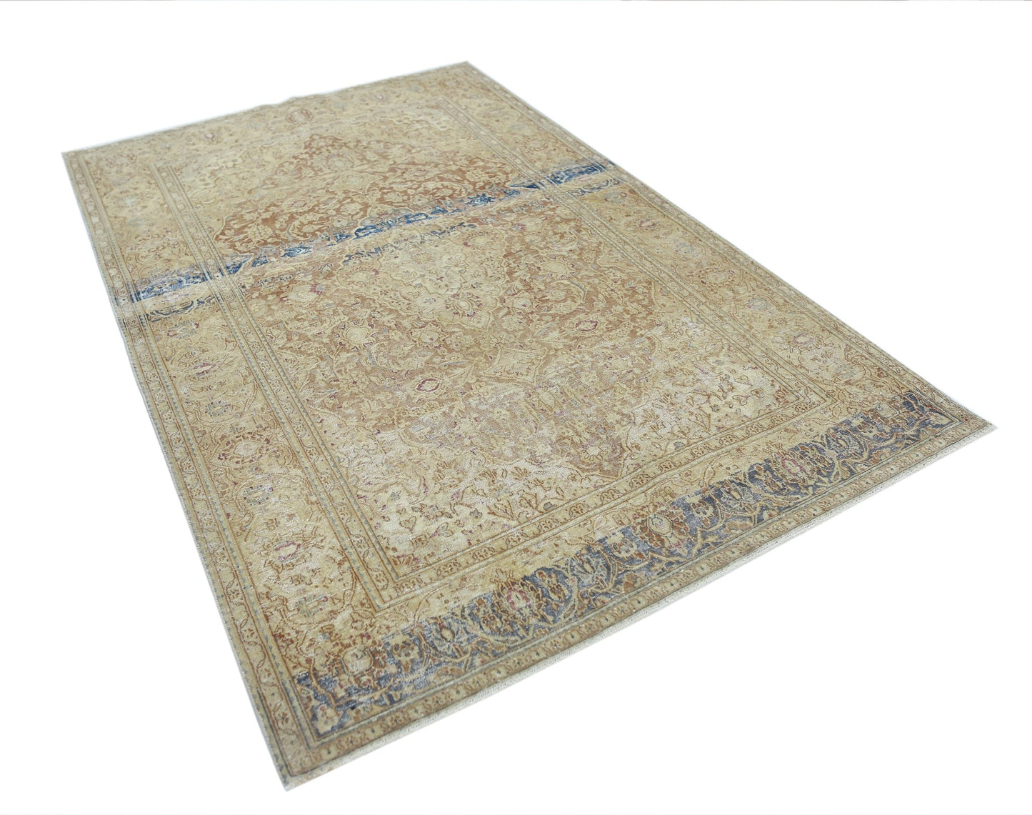 A vintage Persian Kerman rug featuring a central medallion and intricate floral patterns in beige.