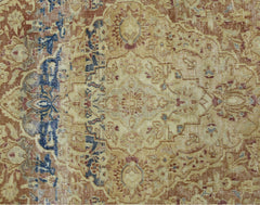 A vintage Persian Kerman rug featuring an intricate floral medallion in muted earth tones.