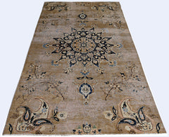 A vintage Persian Kerman rug featuring a central medallion and intricate floral motifs in tan.