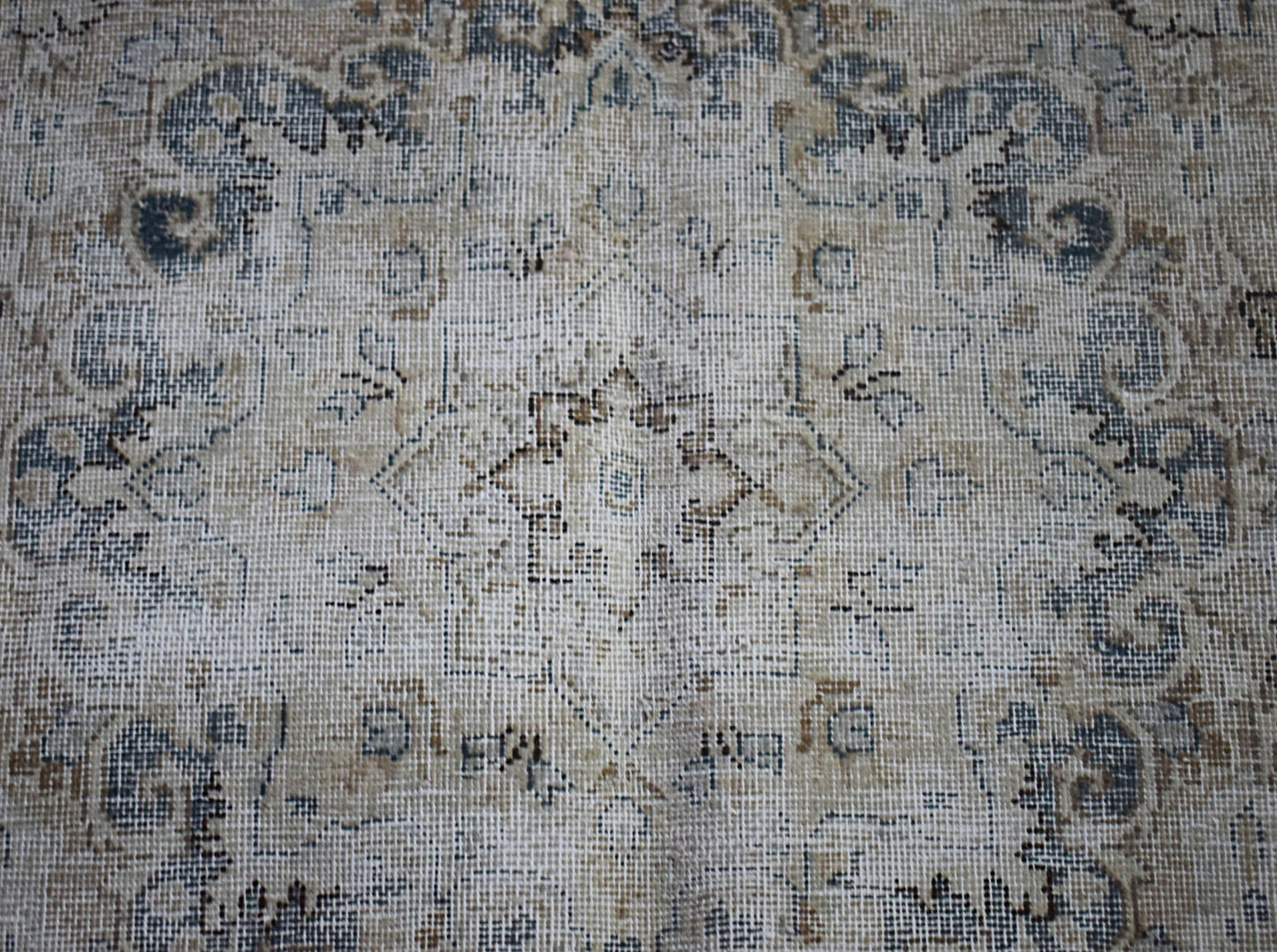 A vintage Persian Kerman rug featuring a central medallion with intricate floral patterns.