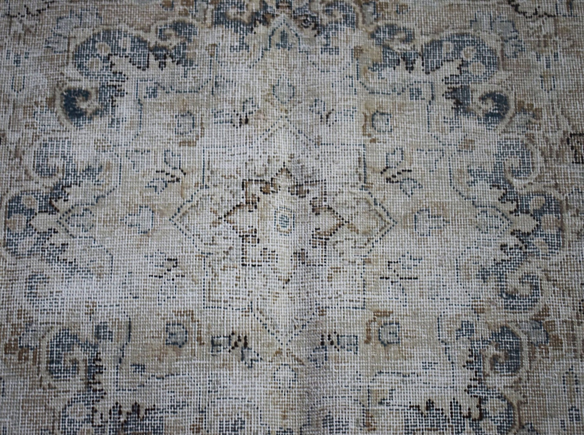 A vintage Persian Kerman rug featuring a central medallion with intricate floral patterns.