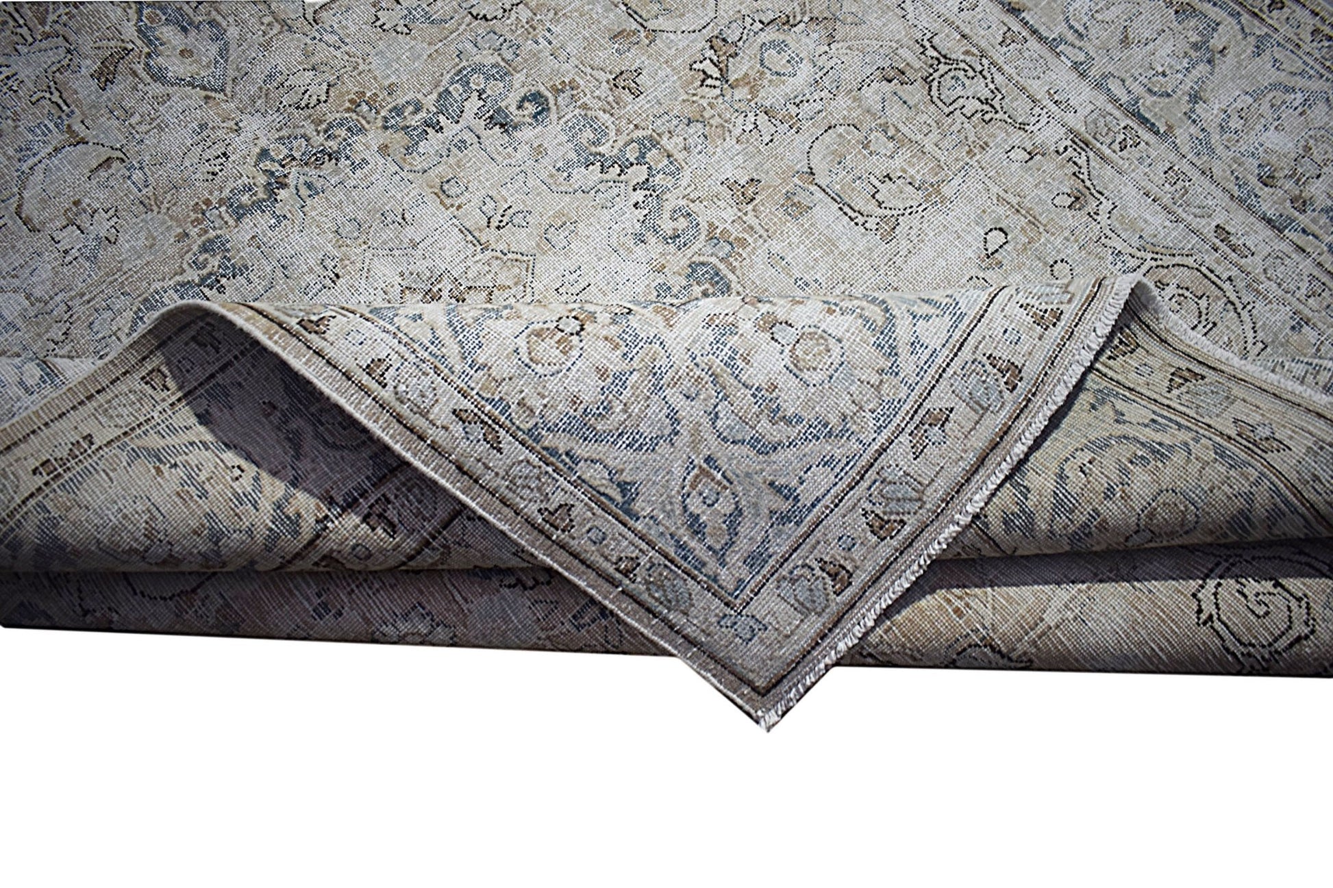 A vintage Persian Kerman rug featuring a faded floral medallion pattern in blue and beige tones.