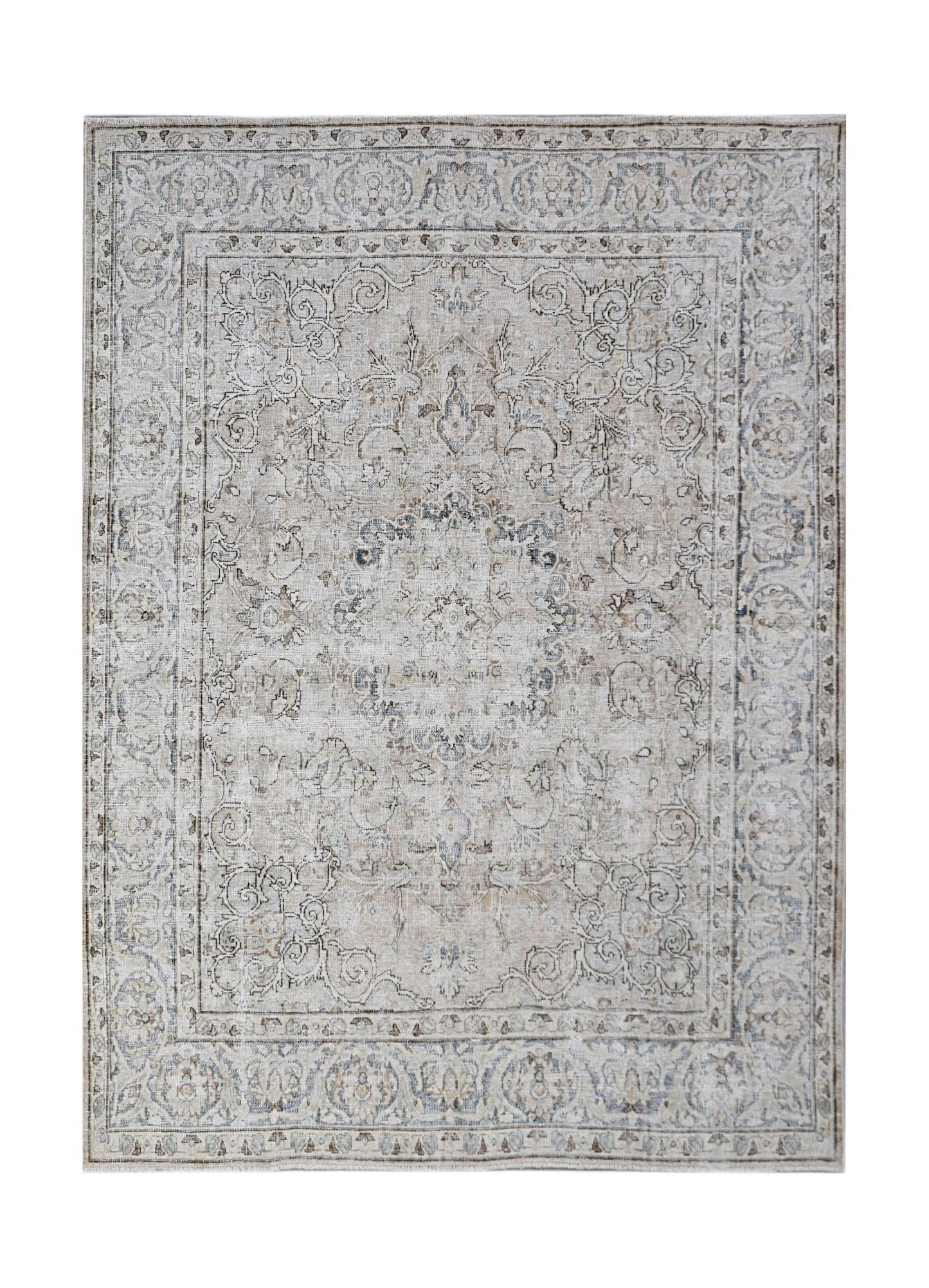 A vintage Persian Kerman rug featuring a central medallion and intricate floral patterns in beige.