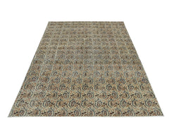 A rectangular vintage Turkish rug featuring a repeating paisley pattern in muted earth tones.