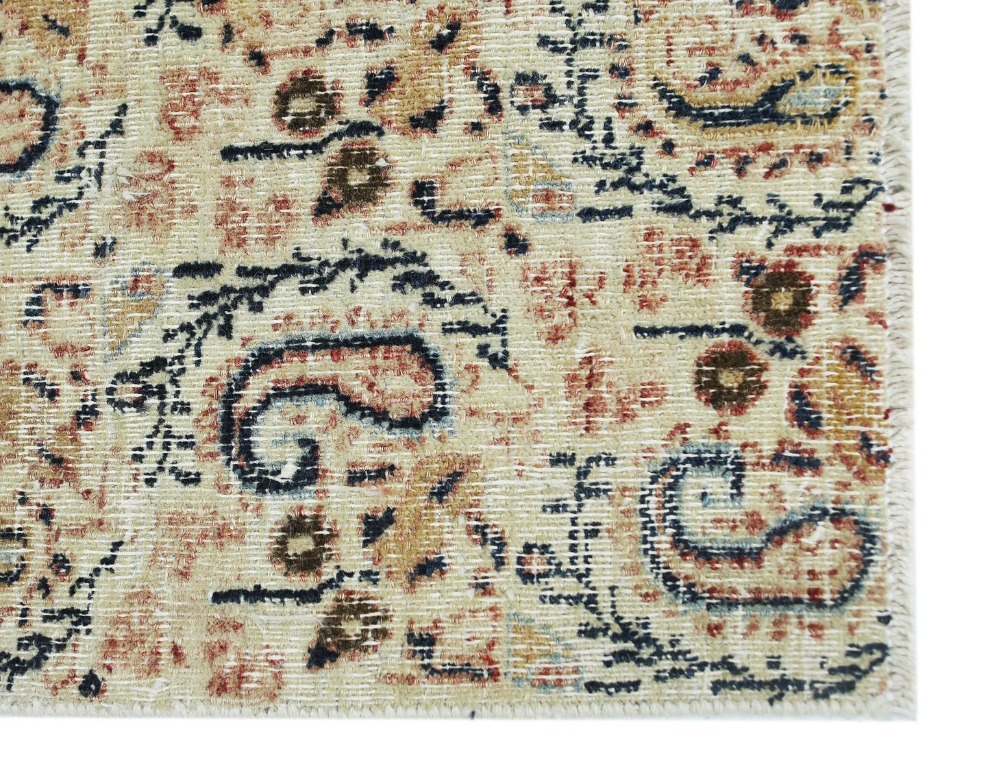 A vintage Turkish rug featuring a distressed floral pattern in muted red, blue, and beige tones.