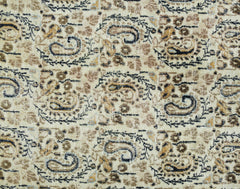 A vintage Turkish rug featuring a repeating paisley pattern in shades of brown, cream, and black.