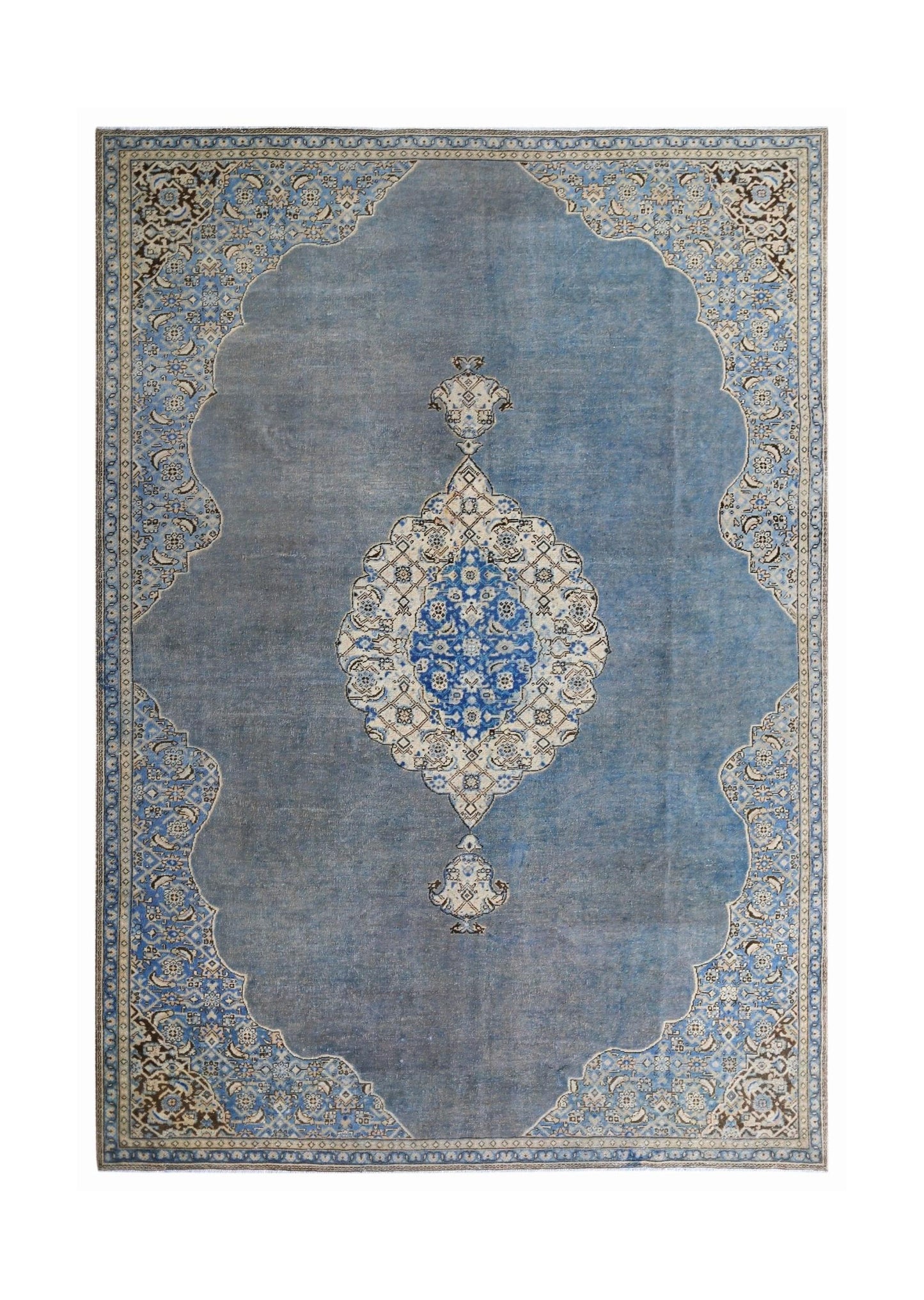 A vintage Persian Kerman rug featuring a central floral medallion on a blue field.