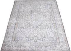 A vintage Persian Kerman rug featuring an intricate floral medallion design in soft blue and cream.