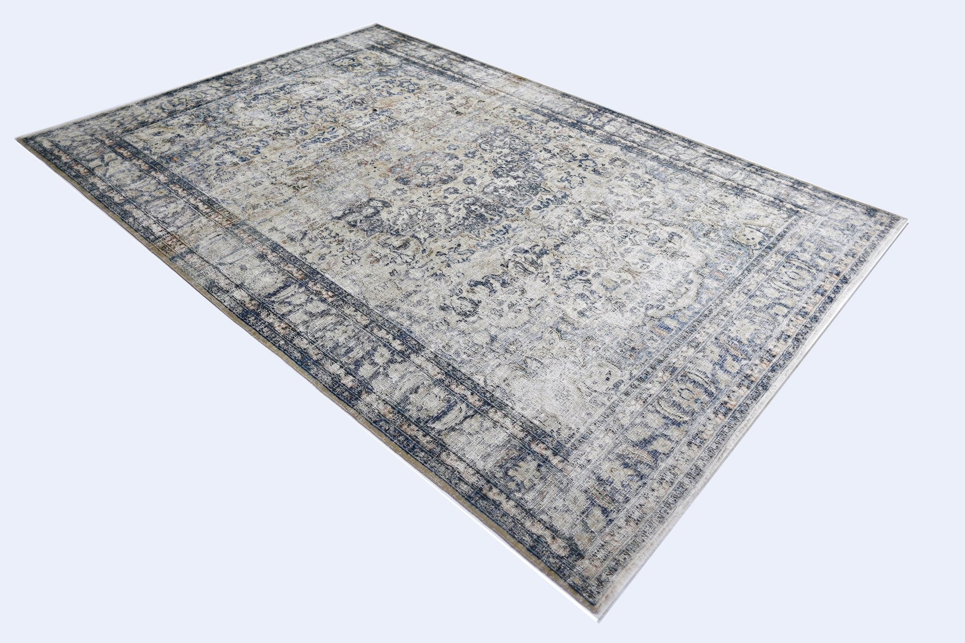 A vintage Persian Kerman rug featuring an intricate blue and cream floral medallion design.