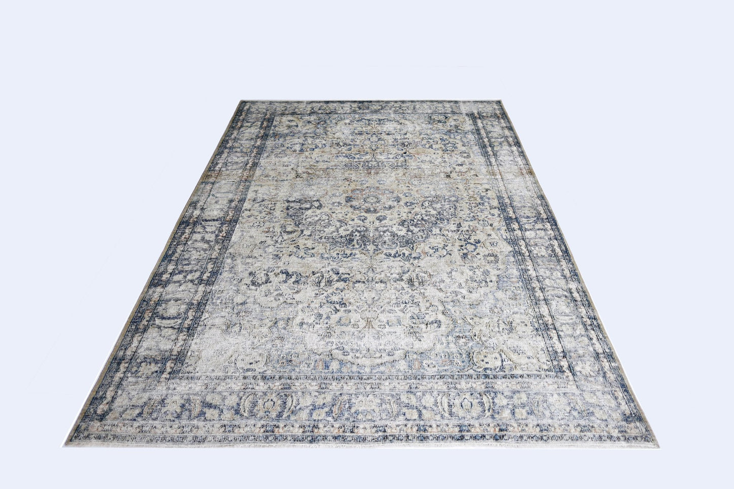 A vintage Persian Kerman rug featuring a central medallion and intricate floral patterns in blue.