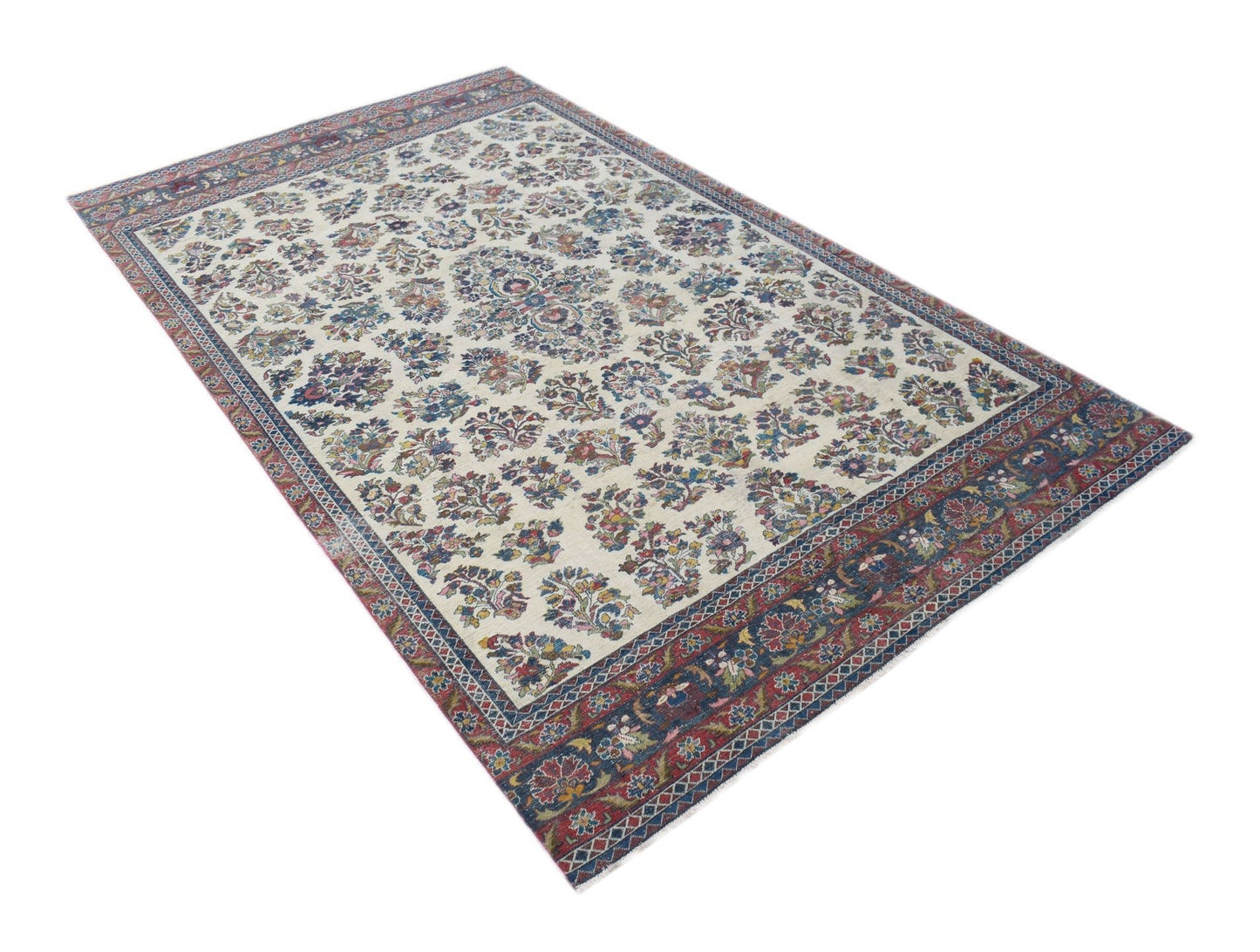 A vintage Persian Kerman rug featuring a central medallion and intricate floral patterns.