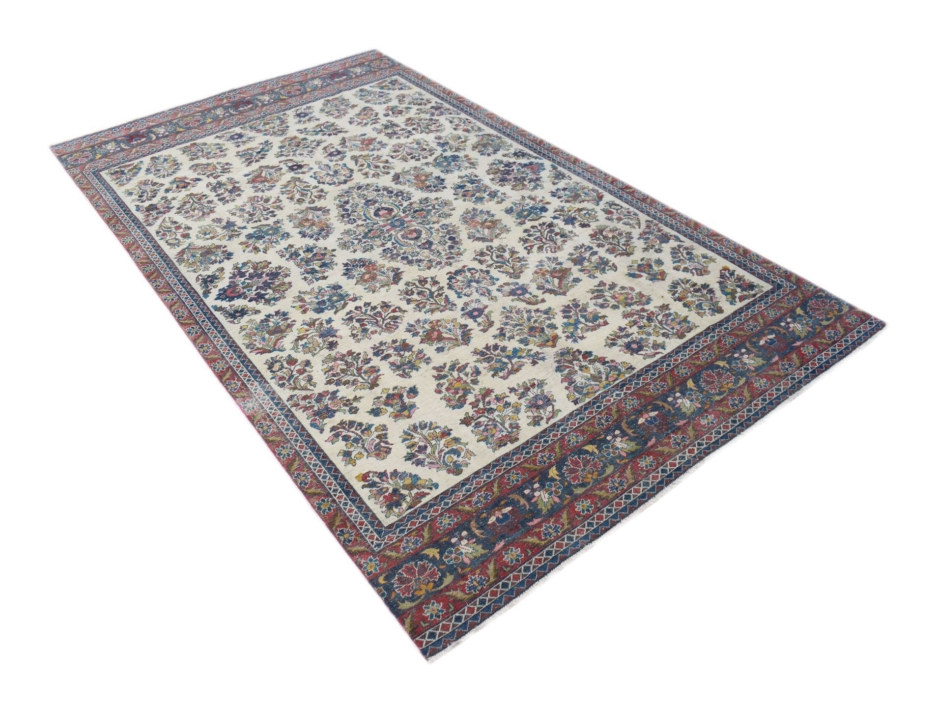 A vintage Persian Kerman rug featuring a central medallion and intricate floral patterns.