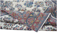 A vintage Persian Kerman rug featuring intricate floral patterns and a detailed border.