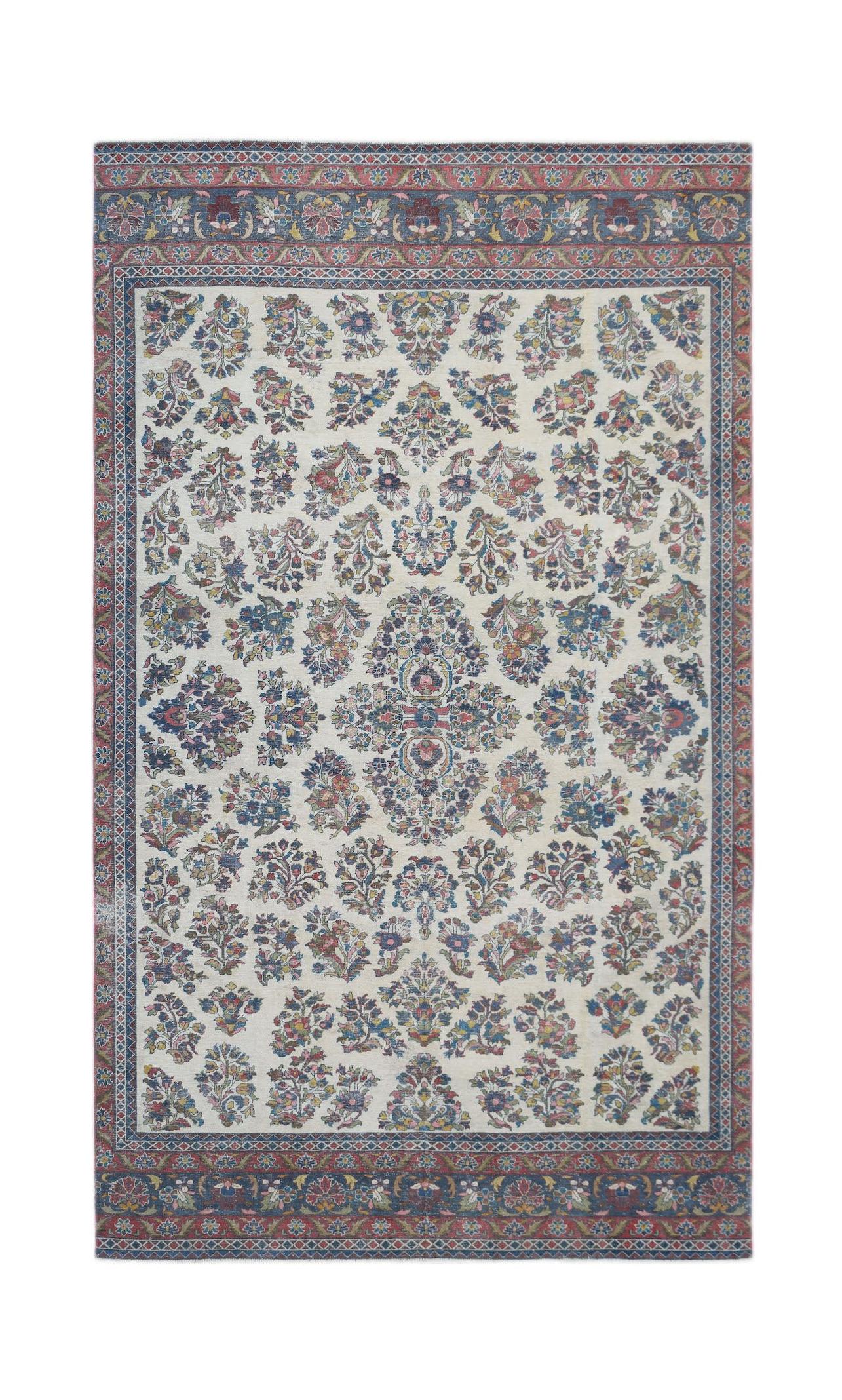 A vintage Persian Kerman rug featuring a central medallion and intricate floral patterns.