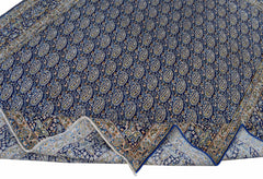 A vintage Persian Kerman rug featuring a dense blue field with an all-over paisley pattern.