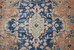 A vintage Persian Kerman rug featuring a central medallion with intricate floral patterns.