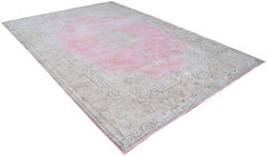 A vintage Persian Kerman rug featuring a faded pink central medallion and intricate floral borders.