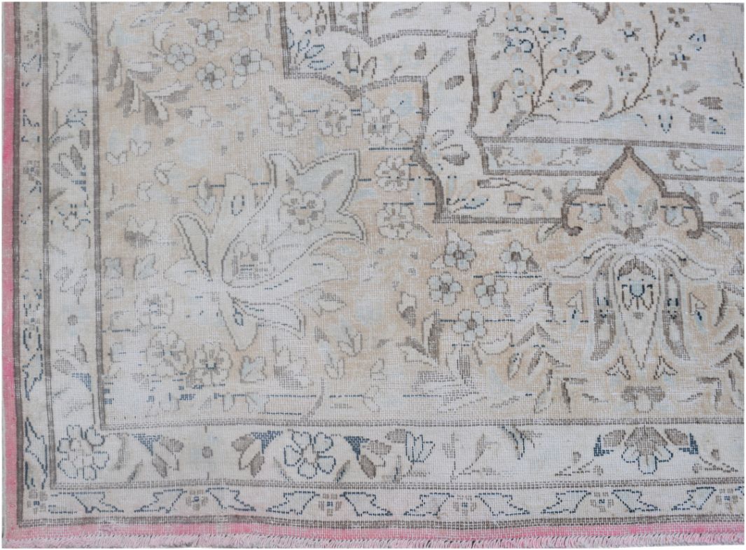 A vintage Persian Kerman rug featuring intricate floral patterns in soft beige and blue tones.