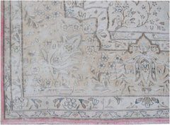 A vintage Persian Kerman rug featuring intricate floral patterns in soft beige and blue tones.