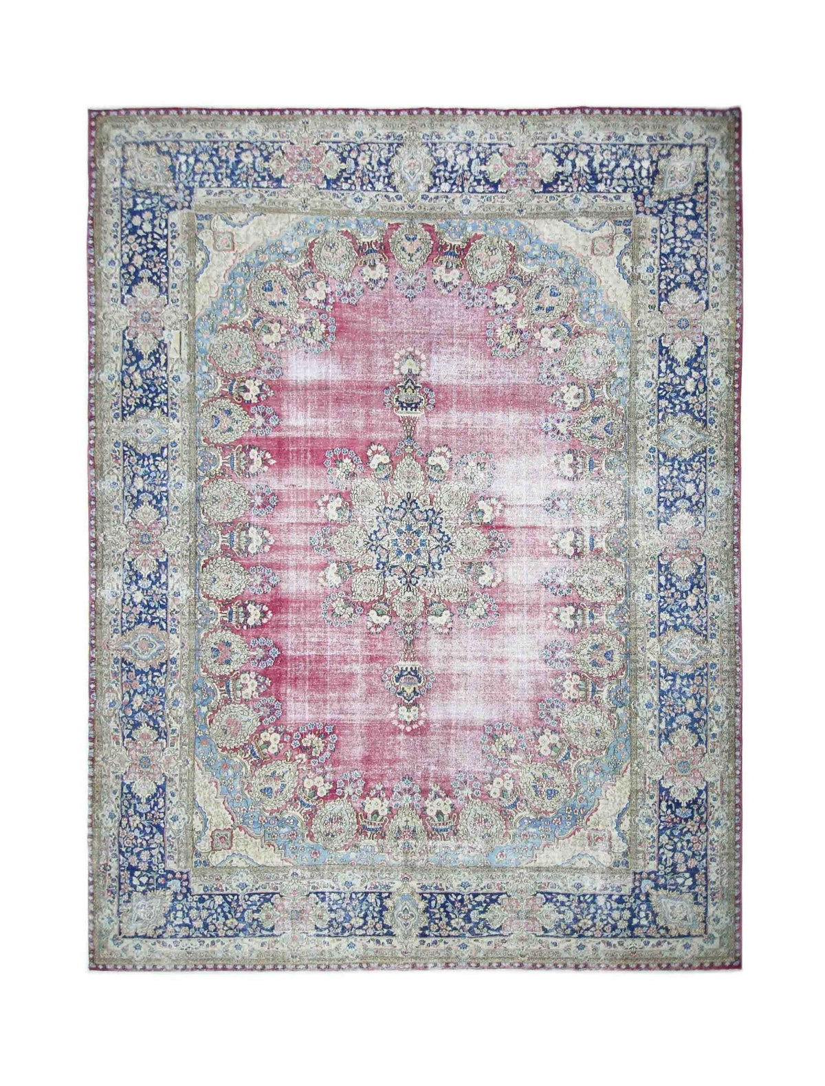 Vintage Persian Kerman rug featuring an ornate central medallion, intricate floral patterns, and a pink and blue colour palette.