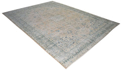 A vintage Persian Kerman rug featuring a central medallion and intricate floral patterns in blue.