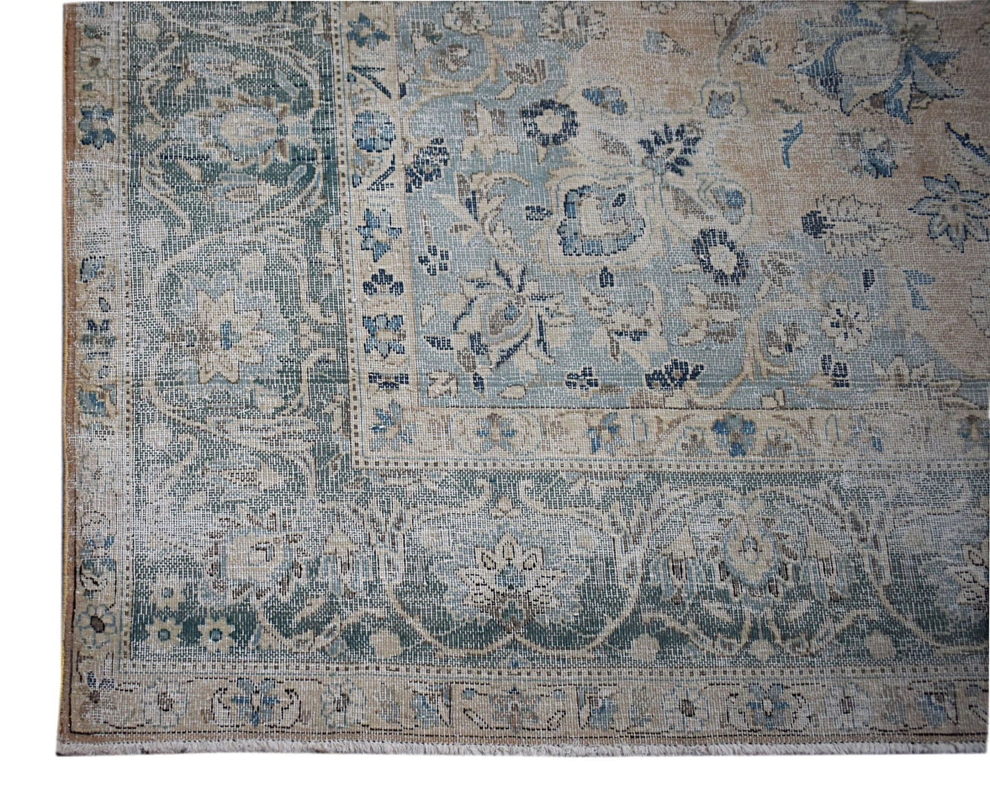 A vintage Persian Kerman rug featuring a faded blue and beige floral pattern with a wide border.