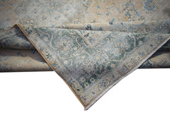 A vintage Persian Kerman rug featuring a faded floral medallion design in blue and beige tones.