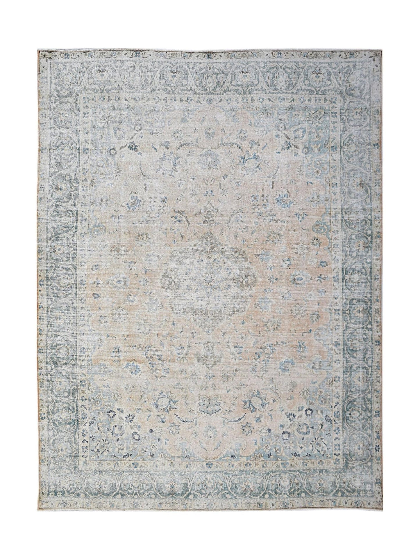A vintage Persian Kerman rug featuring a central medallion and intricate floral patterns in soft tones.