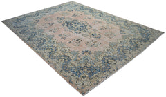 A vintage Persian Kerman rug featuring a central medallion and intricate floral patterns in blue.