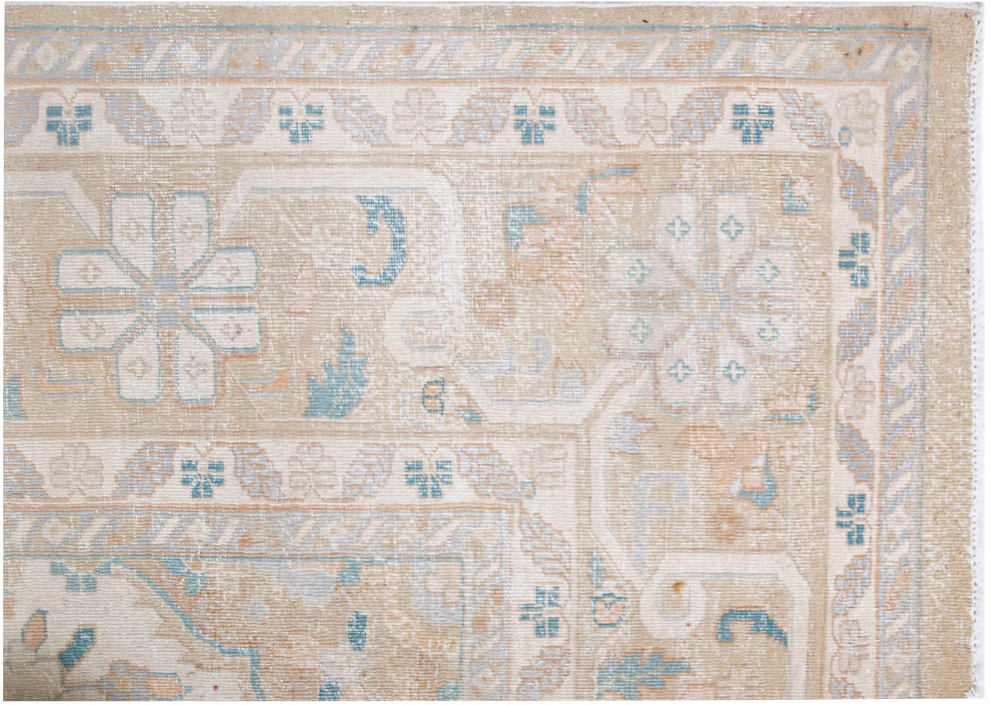 A vintage Persian Kerman rug featuring a soft beige palette with intricate floral medallion motifs.