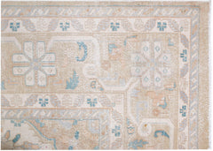 A vintage Persian Kerman rug featuring a soft beige palette with intricate floral medallion motifs.