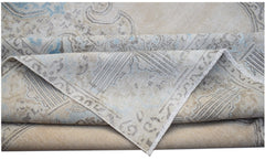 A vintage Persian Kerman rug featuring a beige field with intricate blue and grey floral patterns.